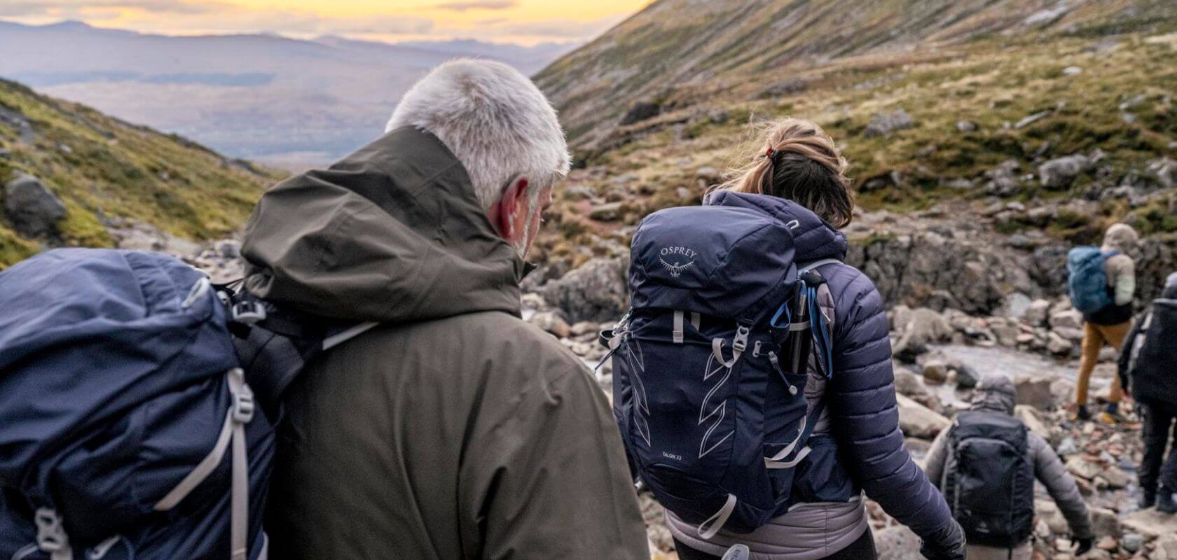 A man and women hiking with Osprey backpacks 