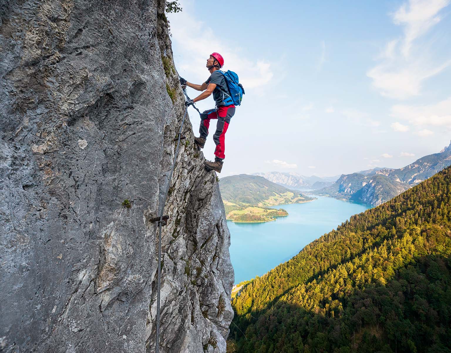 A person is climbing in the summer