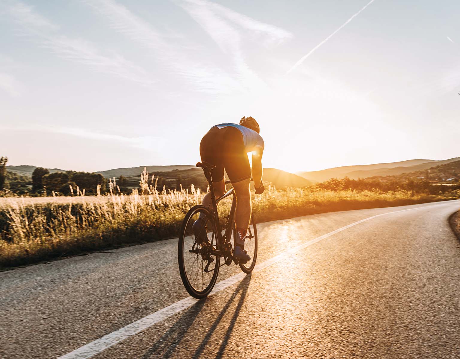 A person is cycling in a rural area