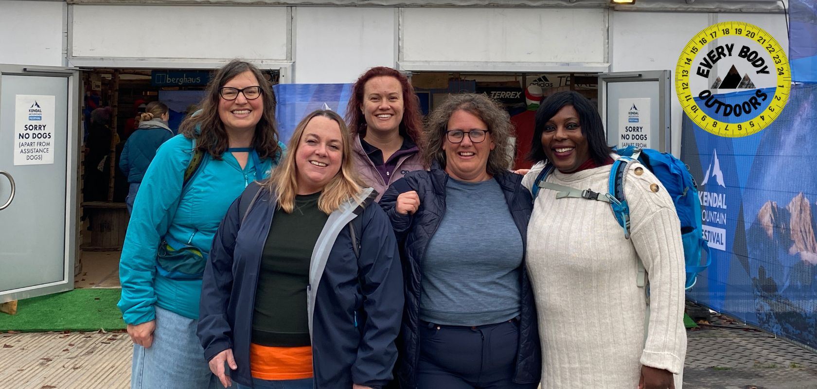 Women from every body outdoors organisation posing together for a photo. The Every Body Outdoors logo is on the right. 