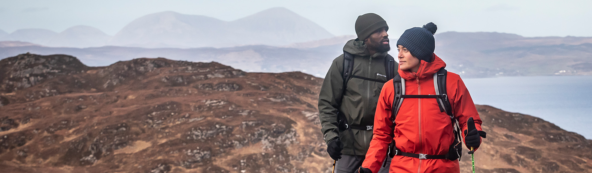 Two people on a hike in Montane clothing 