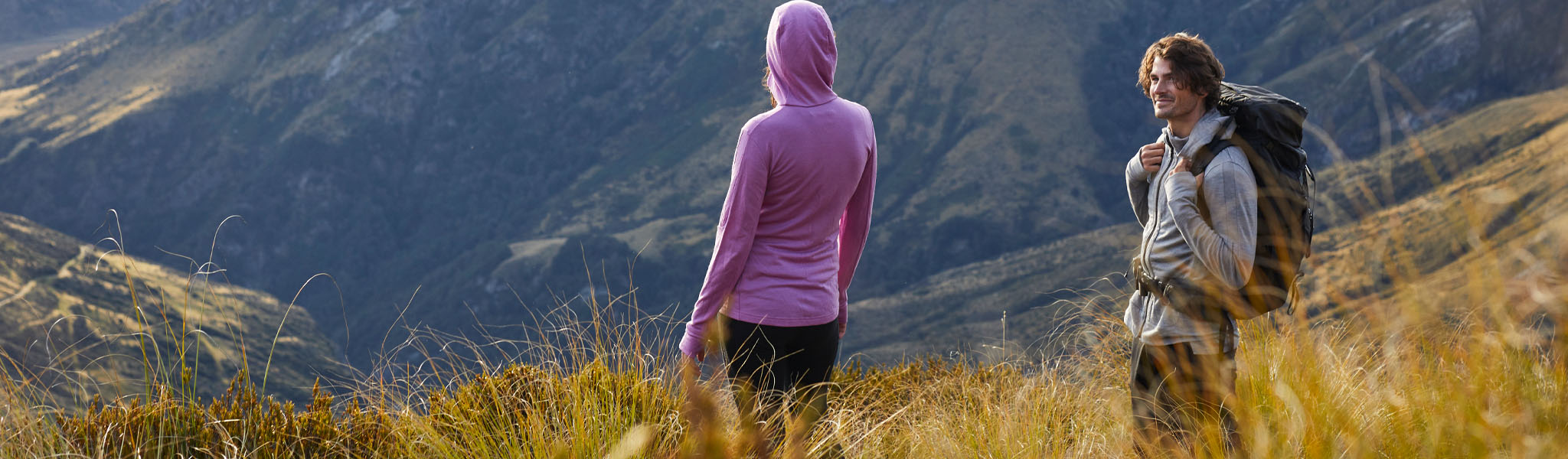 A man and a woman on a hike in Icebreaker clothing 