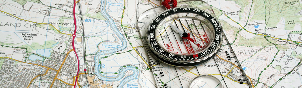 OS maps with a compass on top 