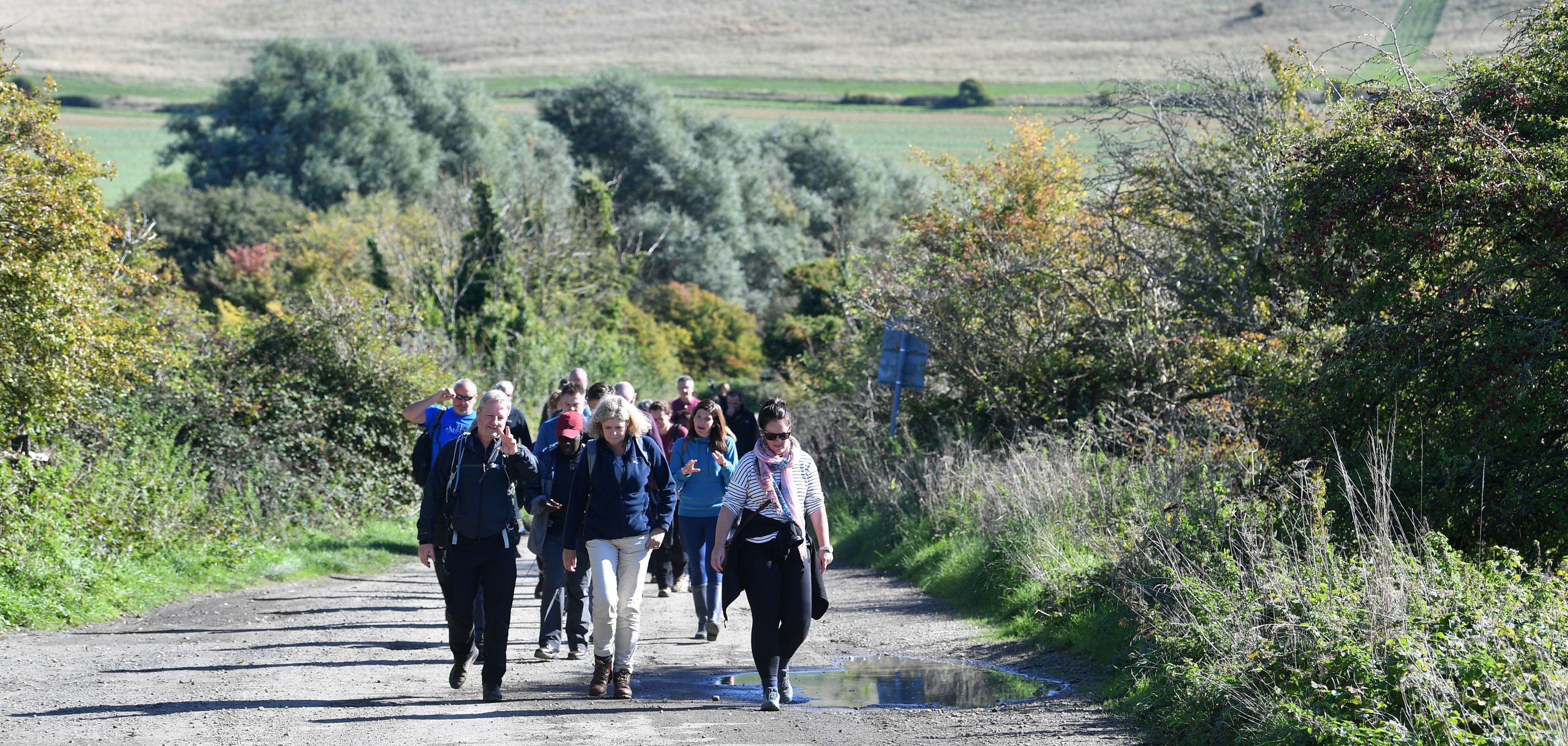 A group of people walking in the countryside