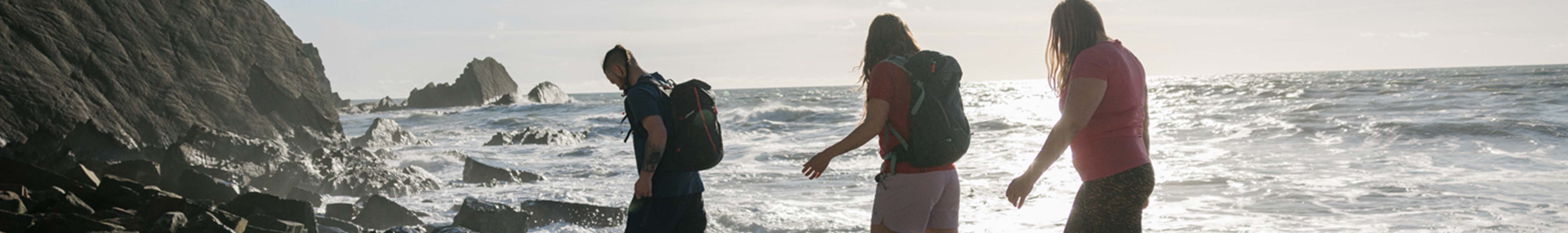 People walking on a rocky beach