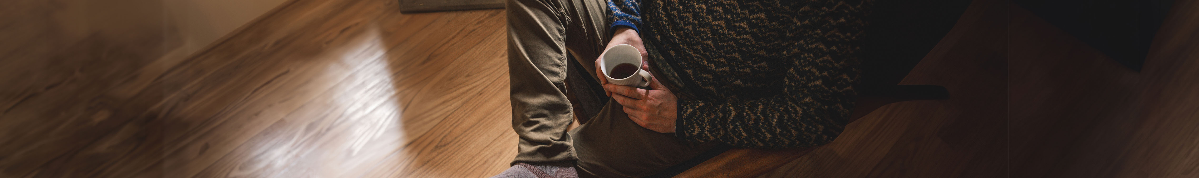 Person relaxing indoors wearing trousers