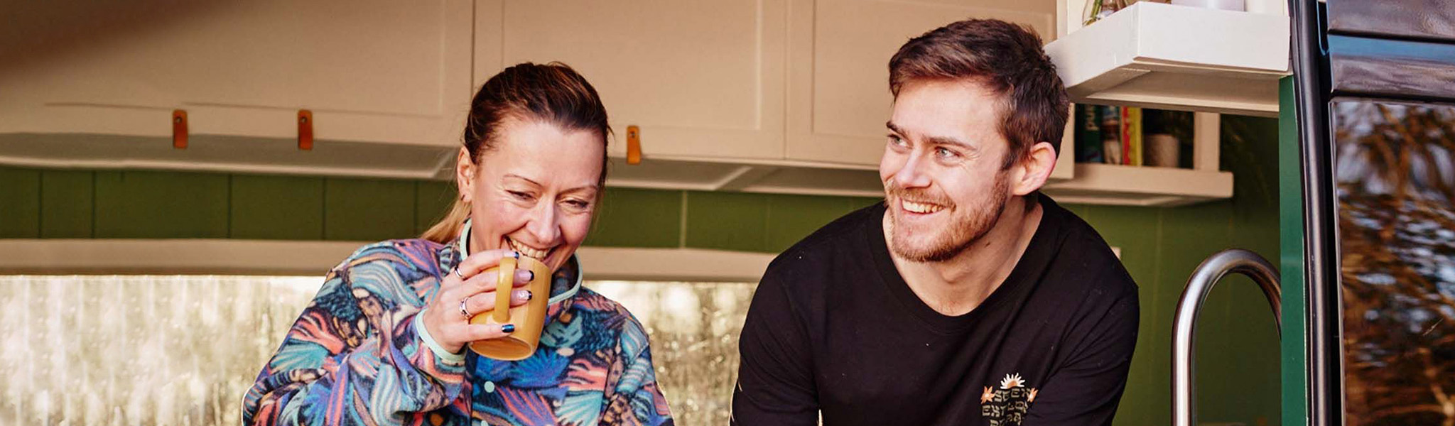 Man and woman in van kitchen