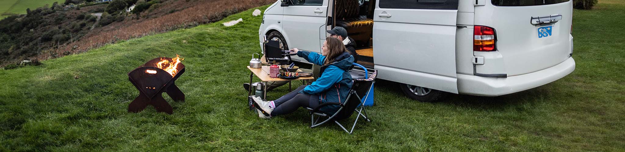 Persons camping near a van