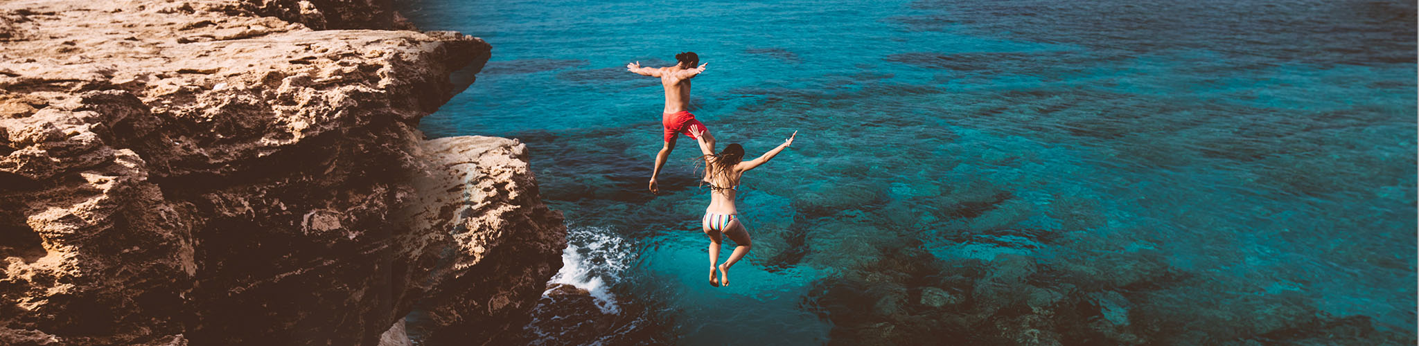 Persons diving in the ocean