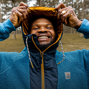 Man putting on a fleece jacket