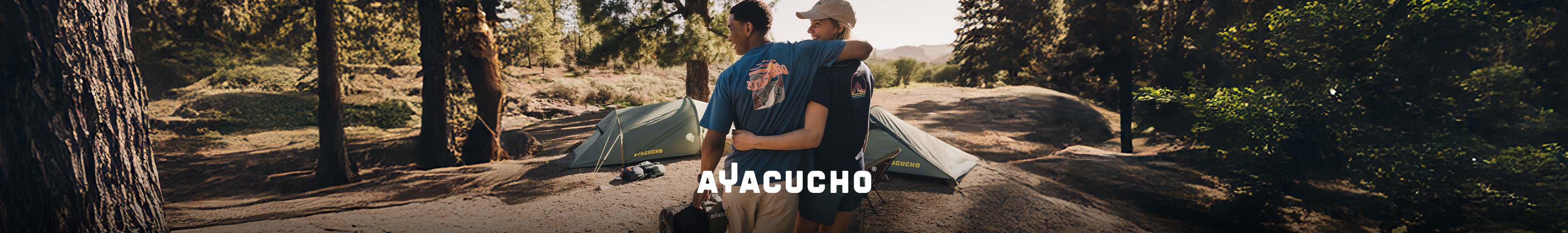 Shop Ayacucho collection. Two people in playful motion in a woodland setting