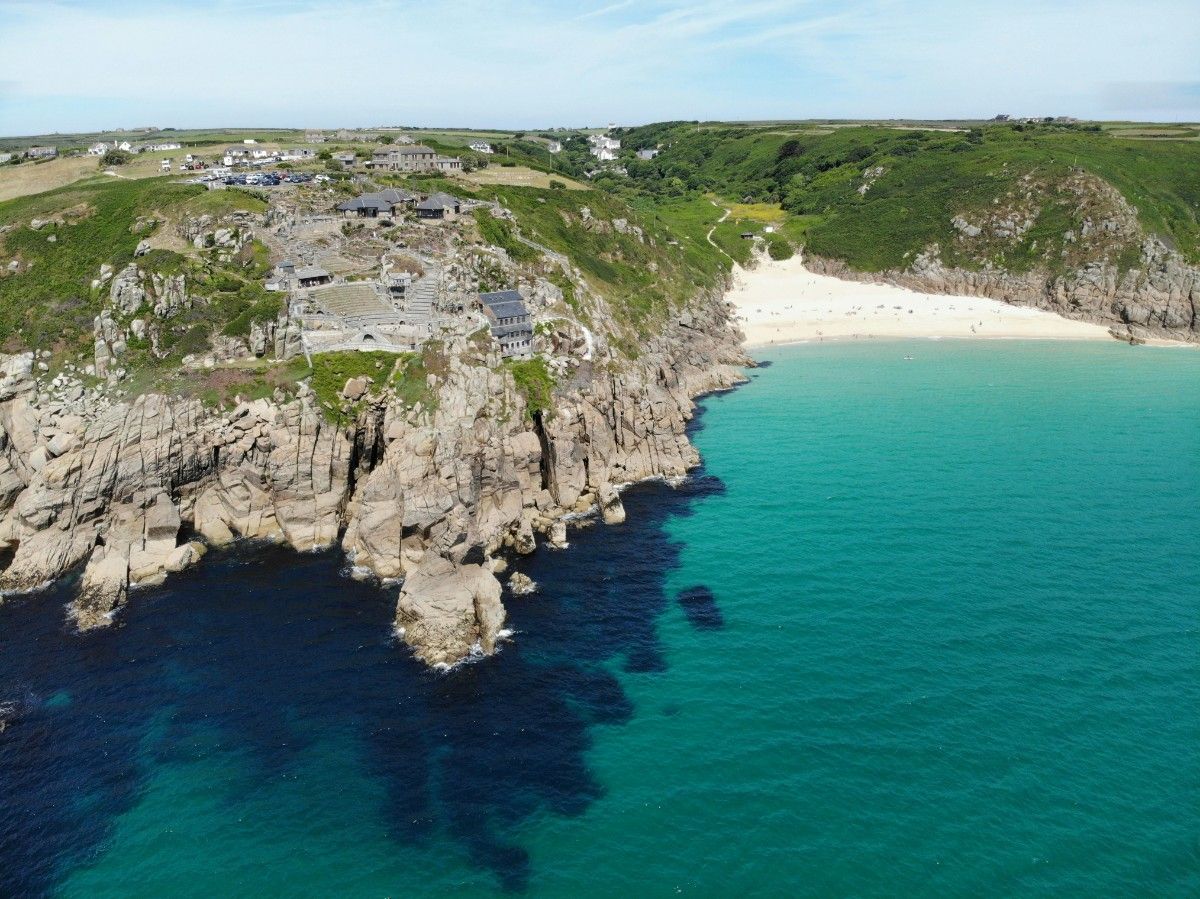 Porthcurno beach with the Mineck Theatre on the cliff