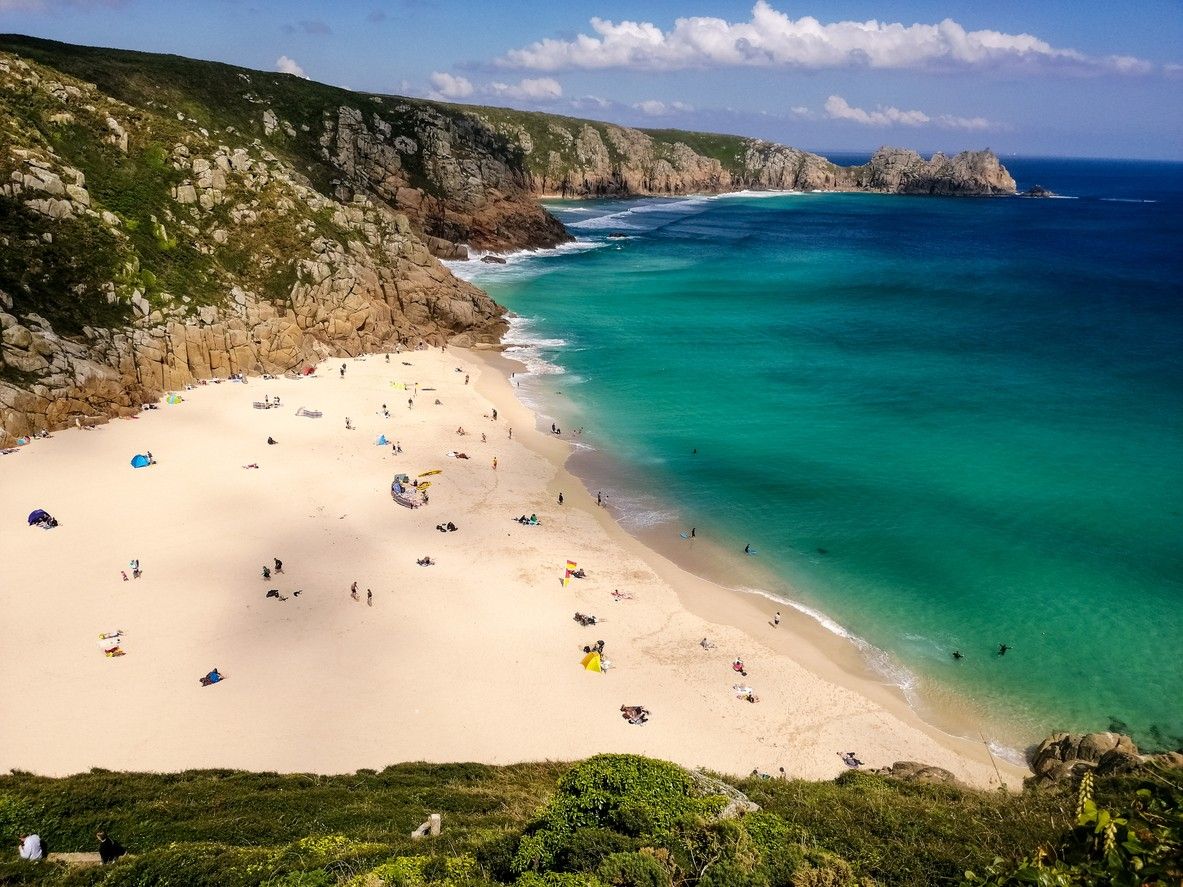 An aerial view of people on Porthcurno beach