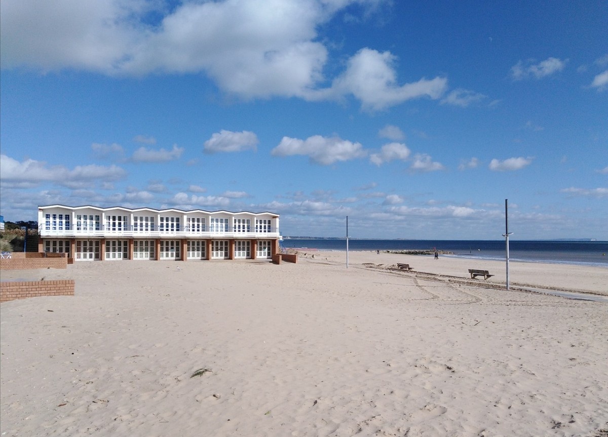 Beach huts along the sand at Sandbanks Beach in Dorset