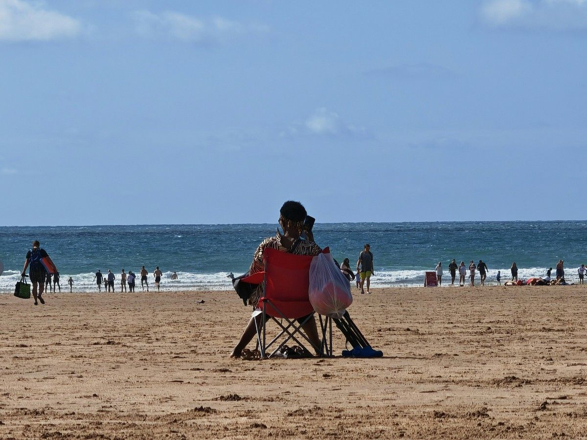 A person in a campchair at Woolacombe Beach