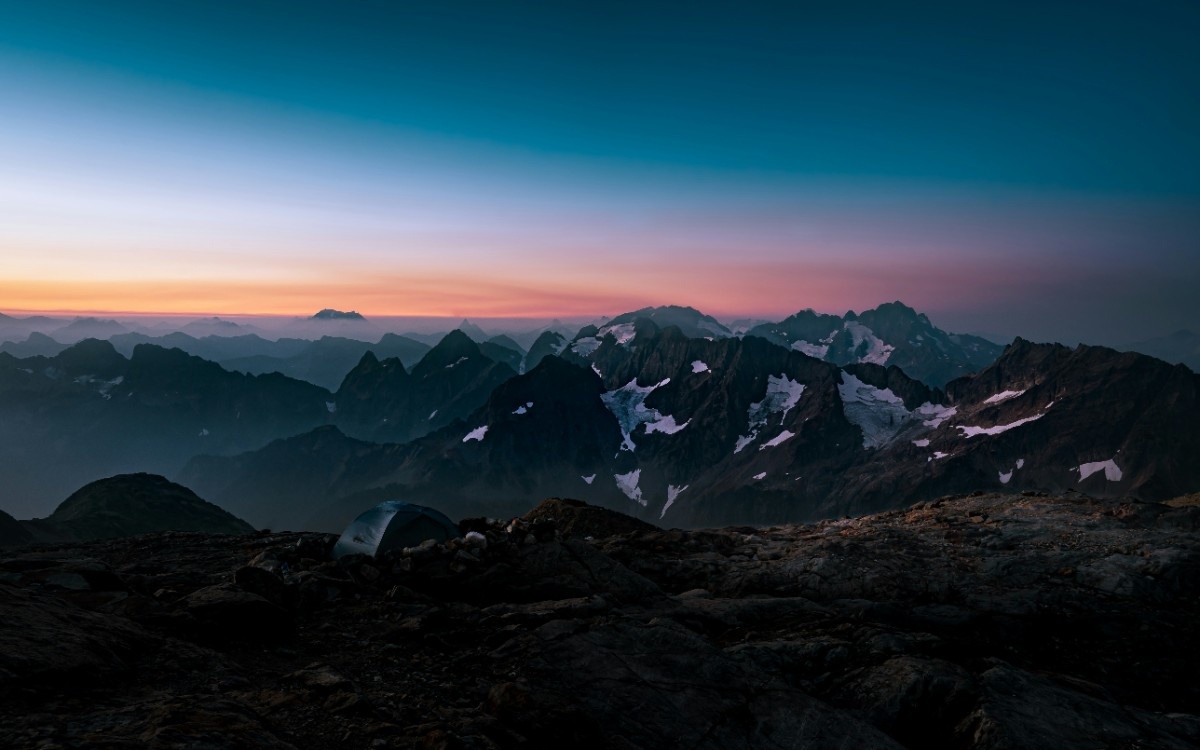 A backpacking tent in the mountains at night 