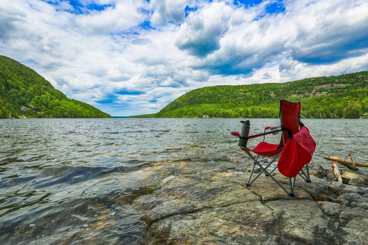 A camp chair by a lake 