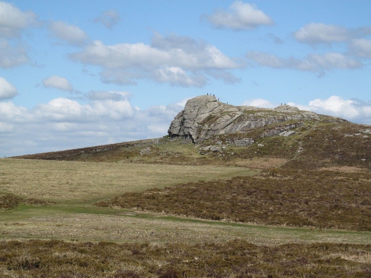 People climbing up a ridge in Dartmoor National Park 