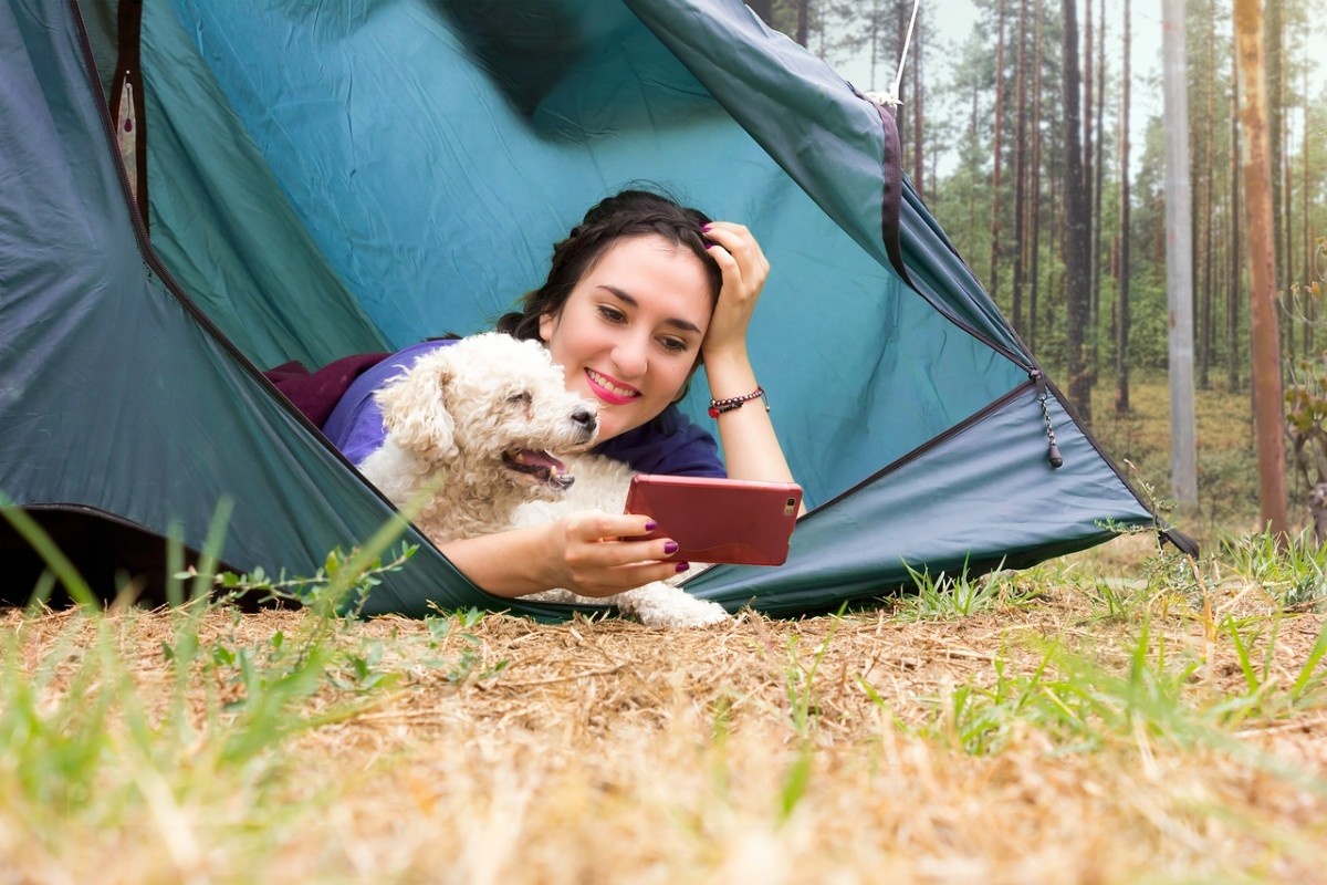 A woman and her dog in a tent