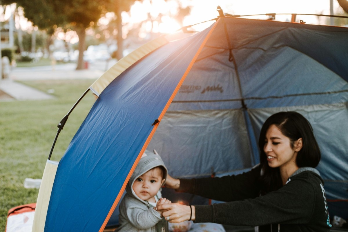 A woman with her child in a tent 