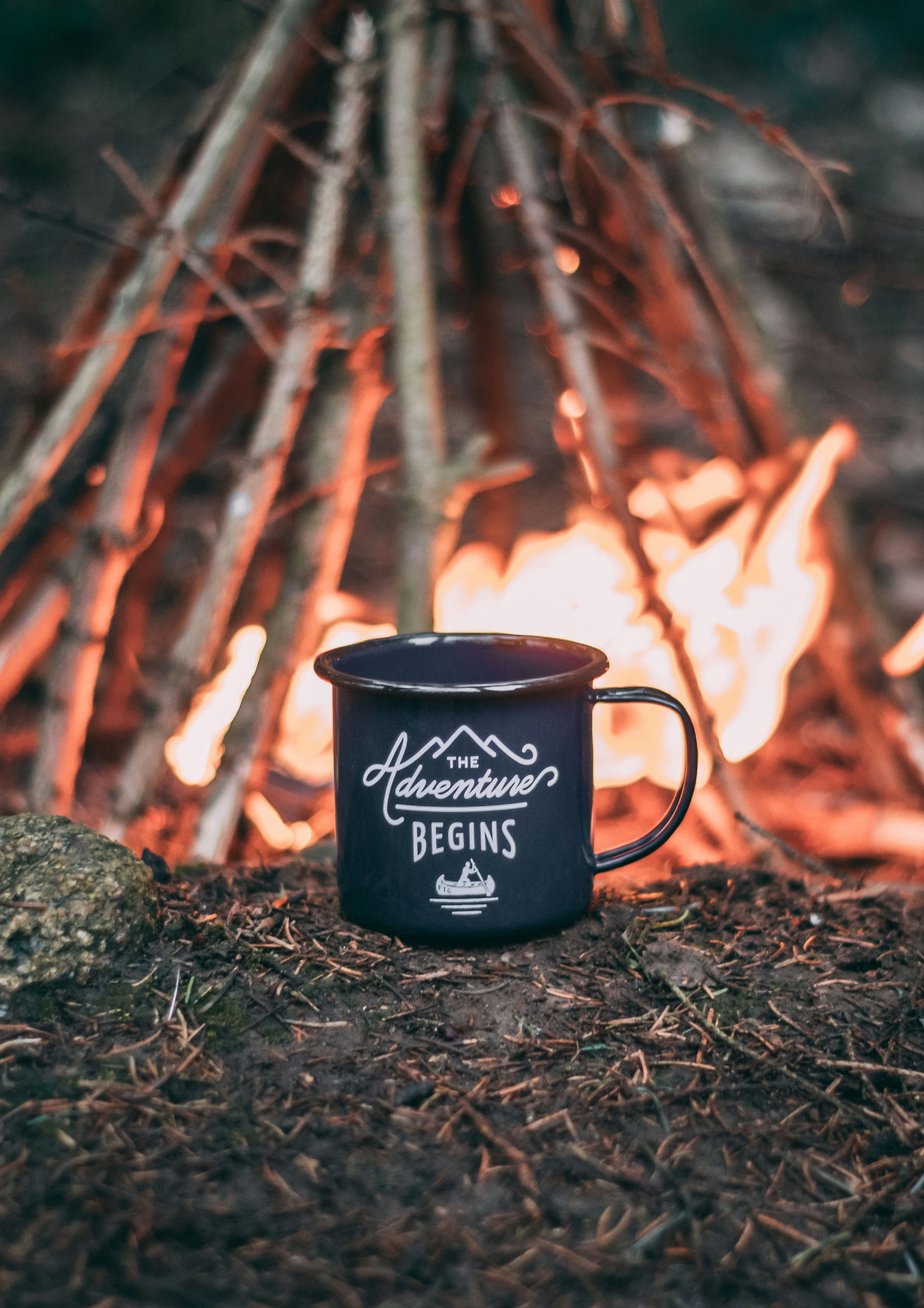 An image of a mug by a campfire 