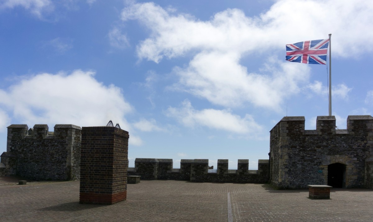 The turrets of Dover Castle with a Union Jack flag flying high