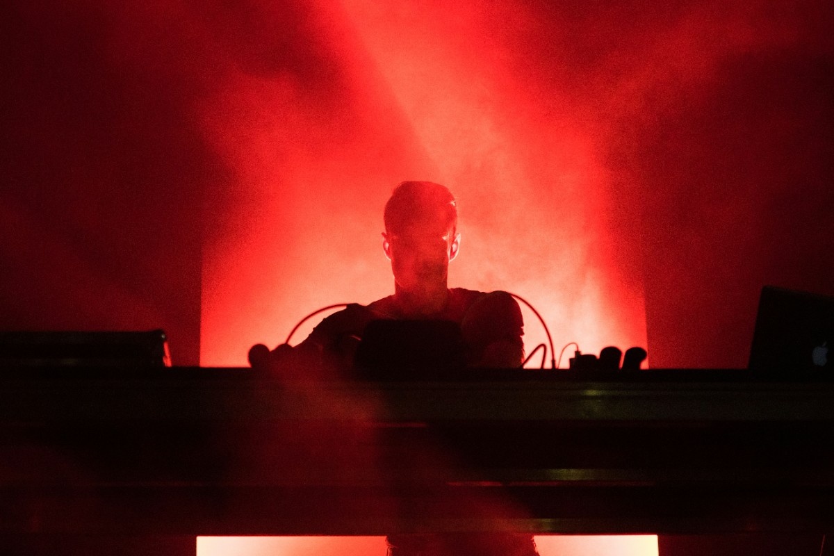 The silhouette of a DJ on stage at Creamfields 