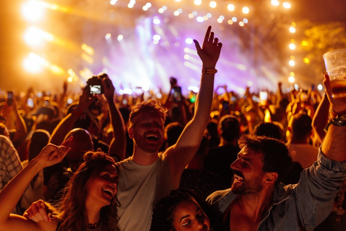 A group of friends dancing at a stage 