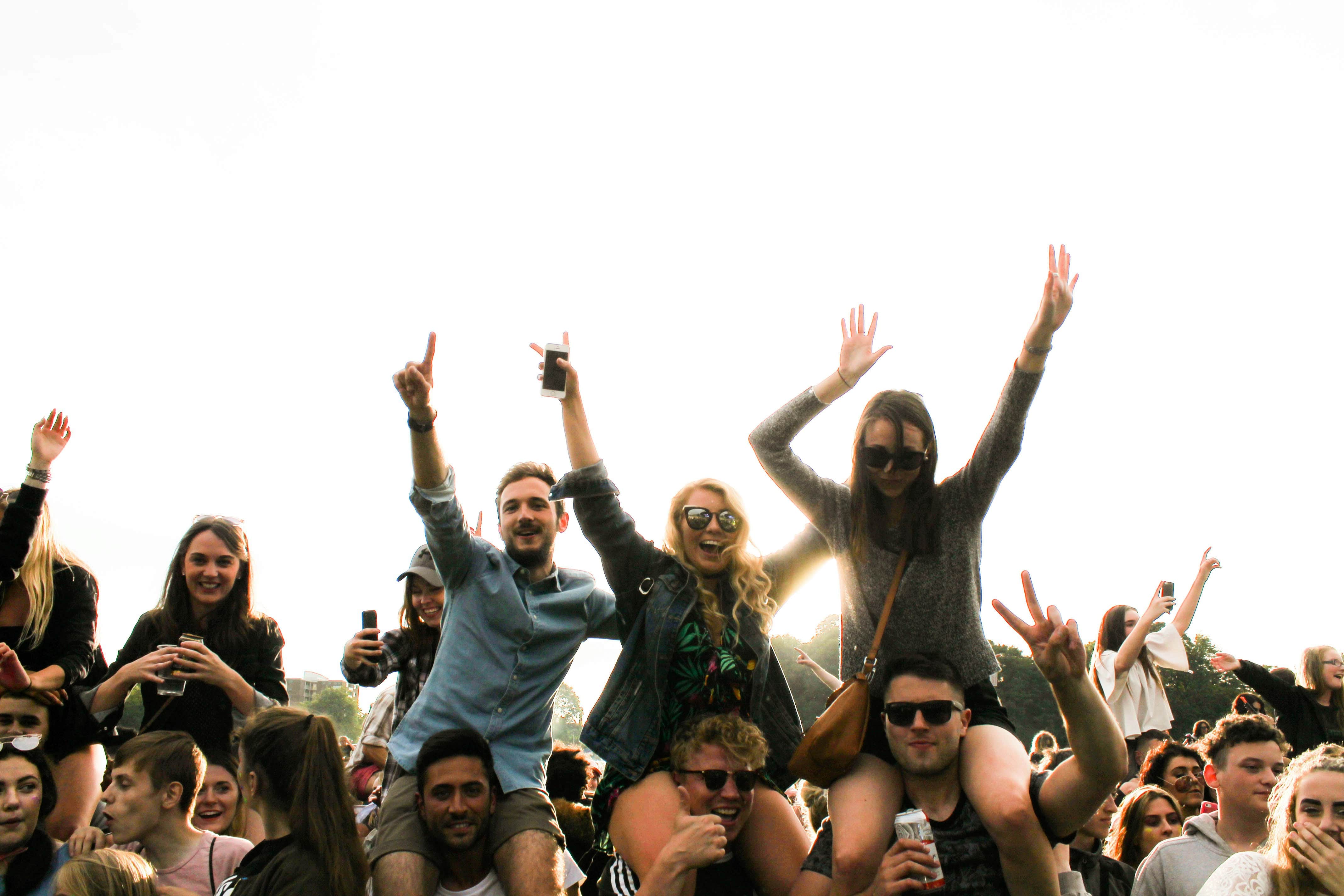 People on their friend's shoulders at in it together festival 