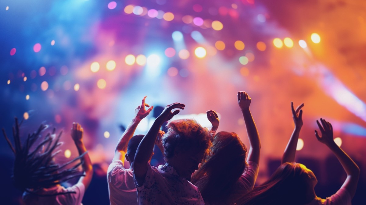 People dancing in a festival crowd