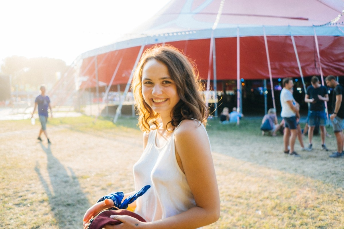 A woman in front of a tent at Sziget Festival