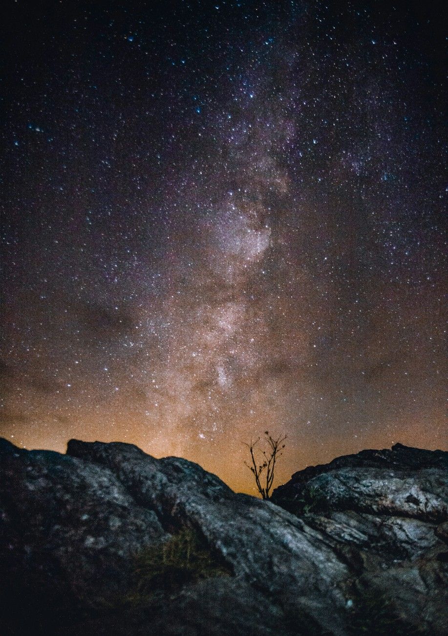 The night sky over a rocky mountain 