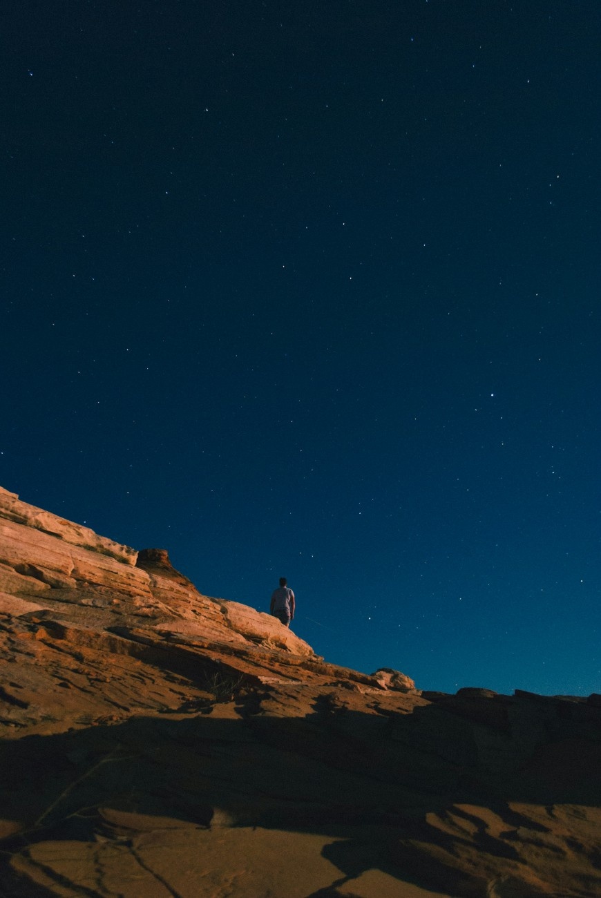 The night sky over a rocky mountain 