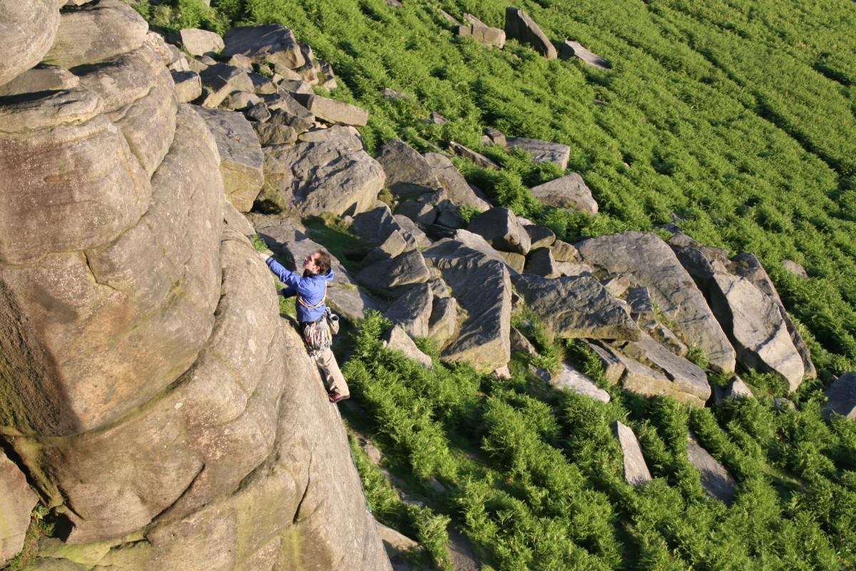 A person climbing at Stanage Edge 