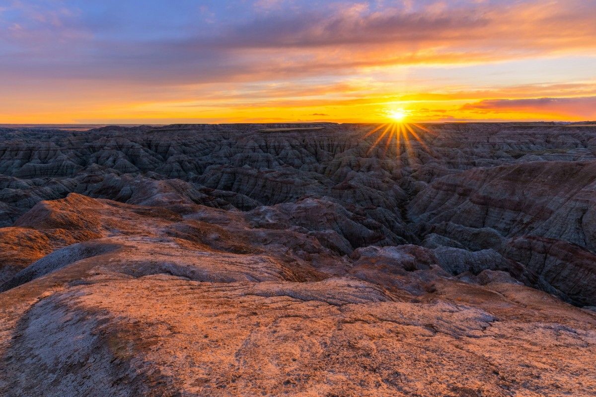 The sun setting over badlands national park 