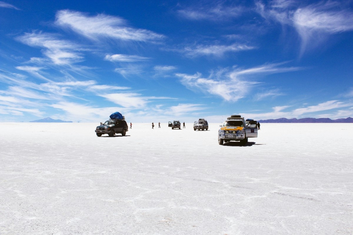 A group of cars and trucks on the Salar de Uyuni salt flats