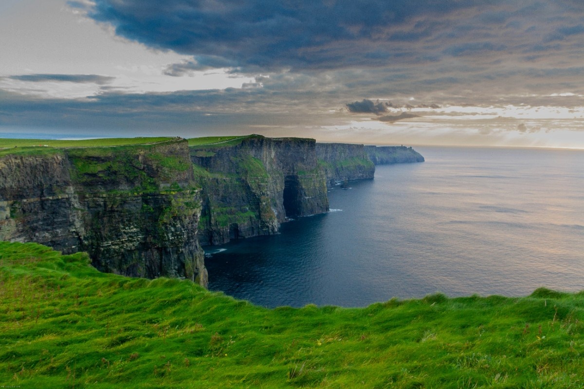 The Cliffs of Moher with a cave in the side of the cliff