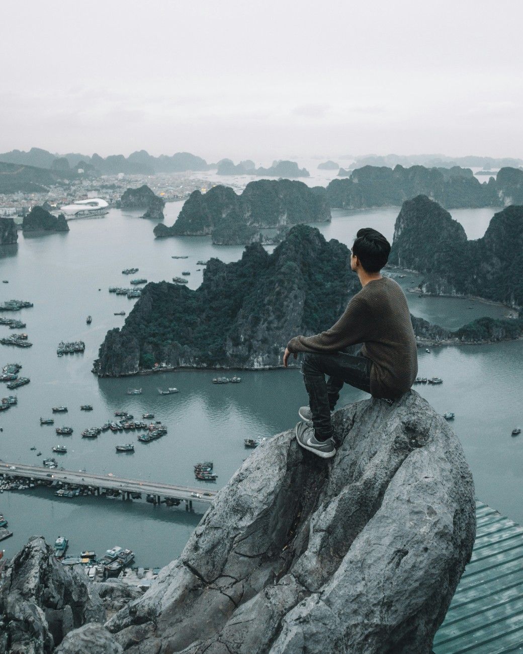 A man sat overlooking Ha Long Bay, Vietnam