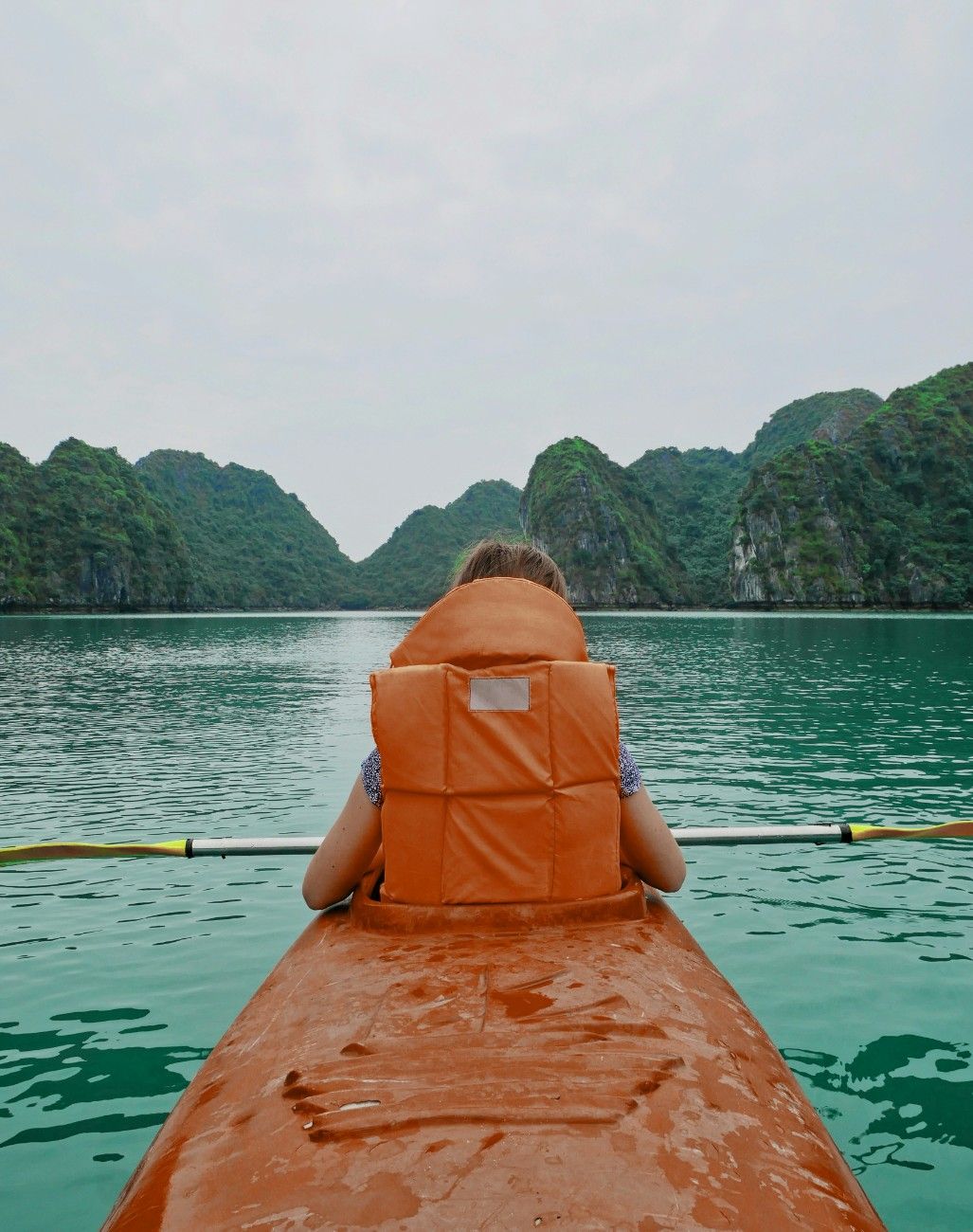 A person kayaking on Ha Long Bay, Vietnam