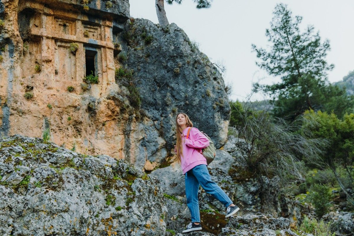 A woman on the Lycian Way in an ancient forest 