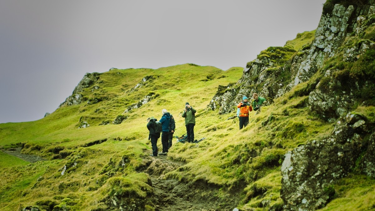 A group of people hiking The Quiraing