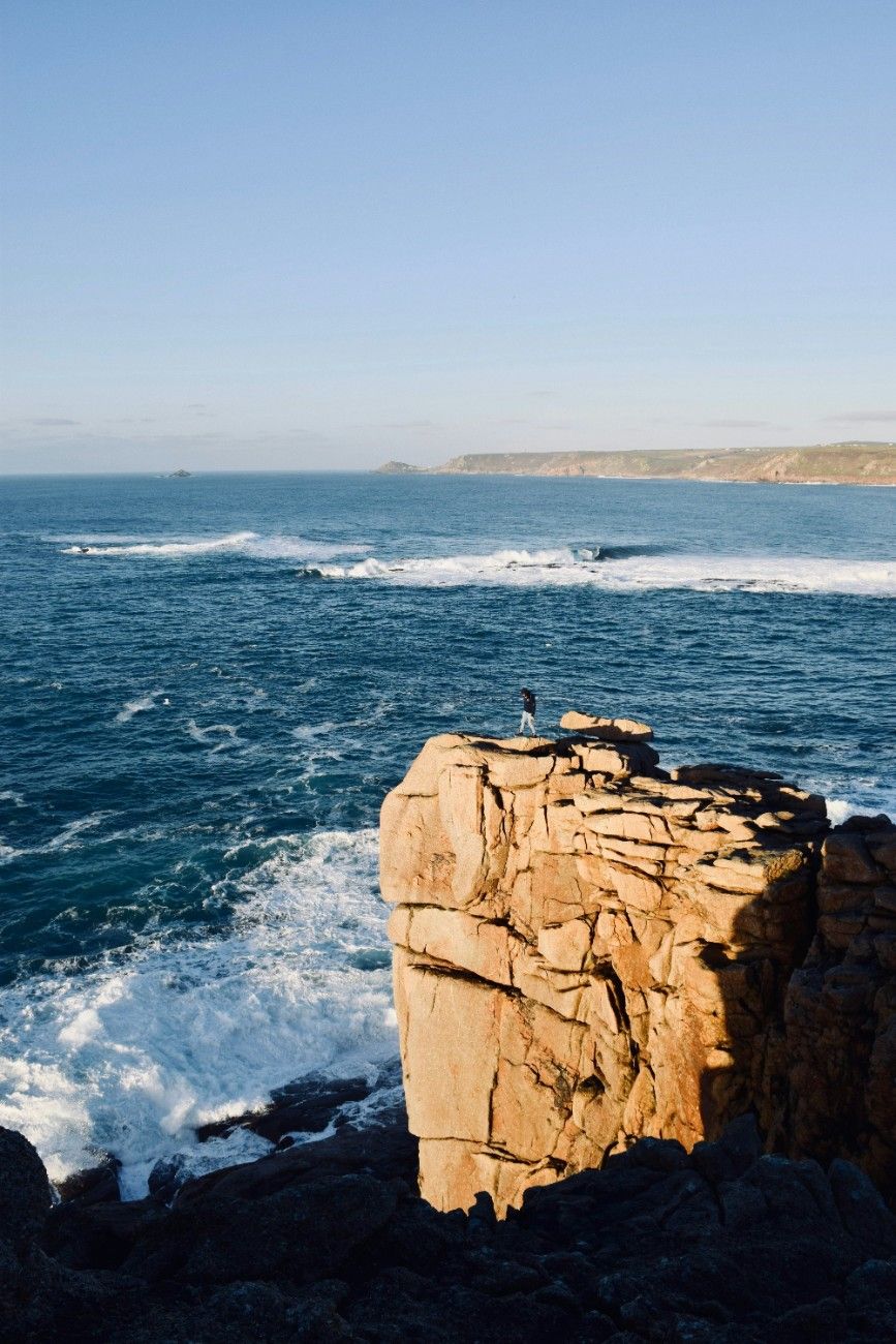 The waves crashing on the rocks in Sennen Cove