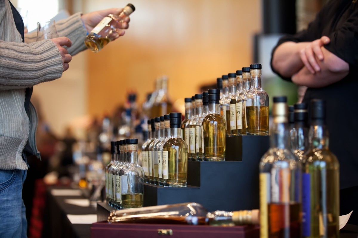 A person looking at a Whisky bottle on the Speyside Way