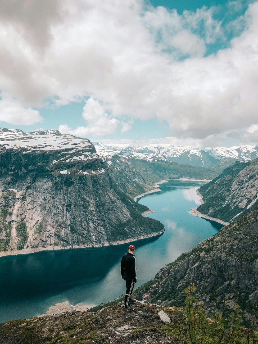 A person looking out at the lake at Trolltunga