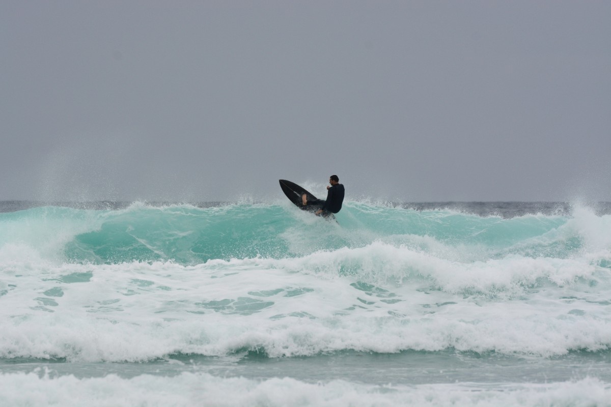 A surfer at Watergate Bay