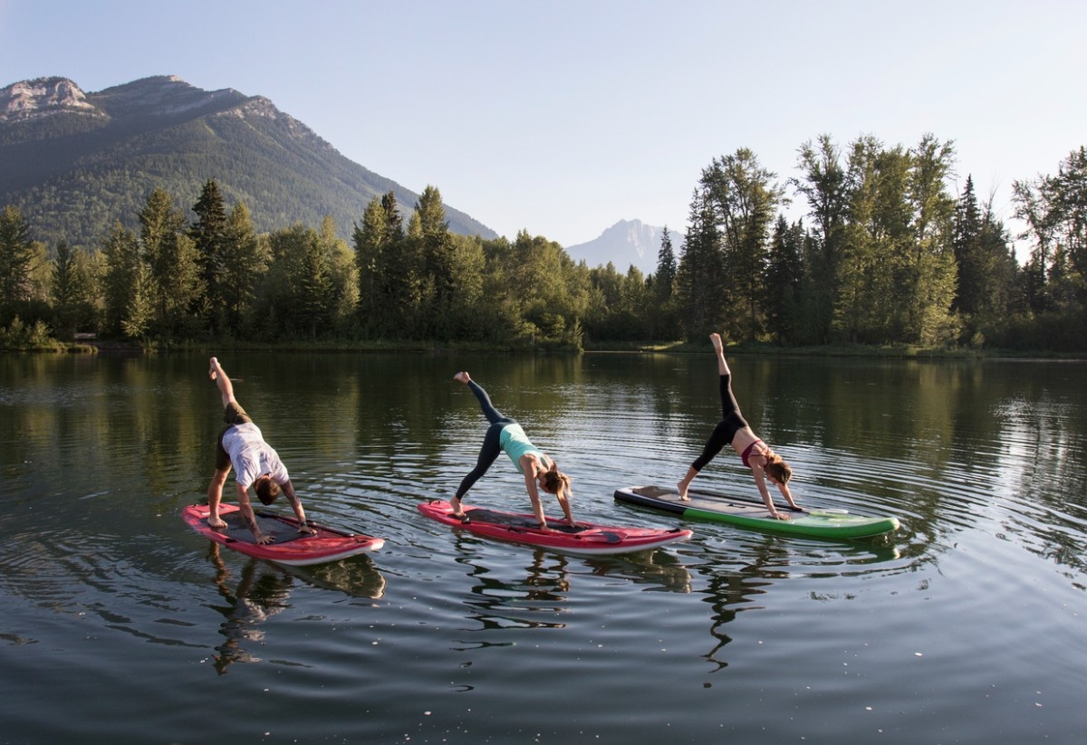 Three women doing SUP yoga