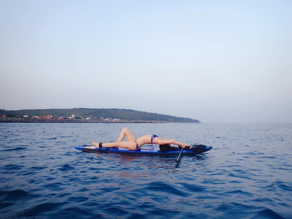 A woman doing SUP yoga