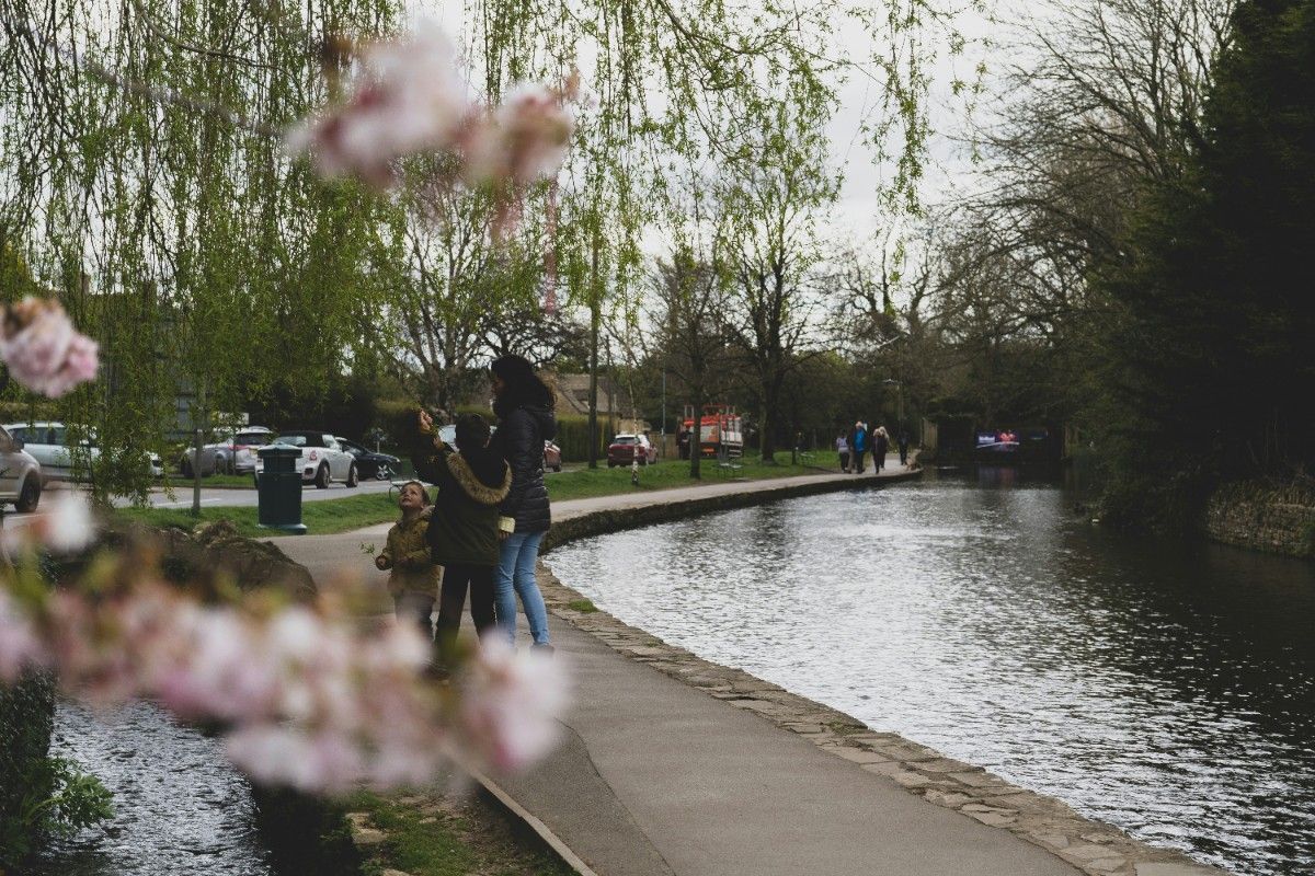 A family in Bourton on the Water by the river