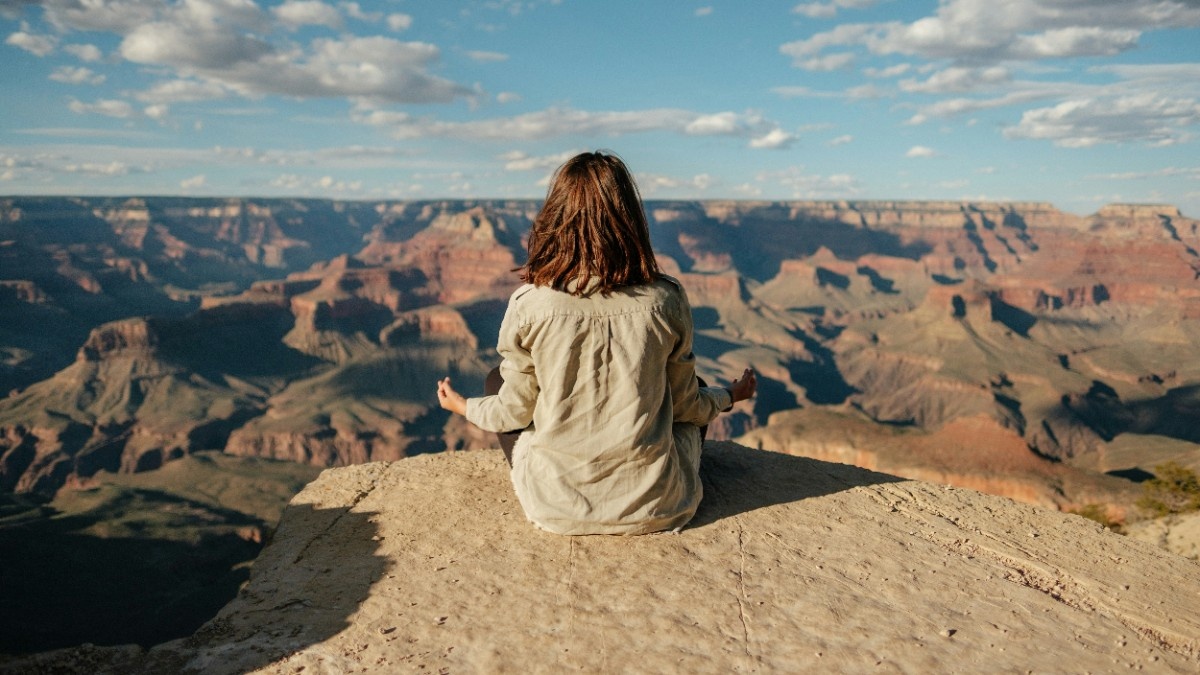 A person meditating on a mountain 