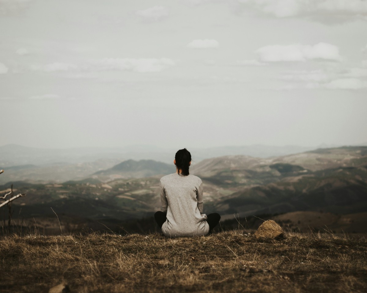 A person meditating on a mountain 